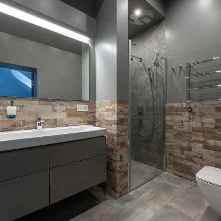 Sleek modern bathroom featuring a glass shower, floating vanity, and stylish decor.