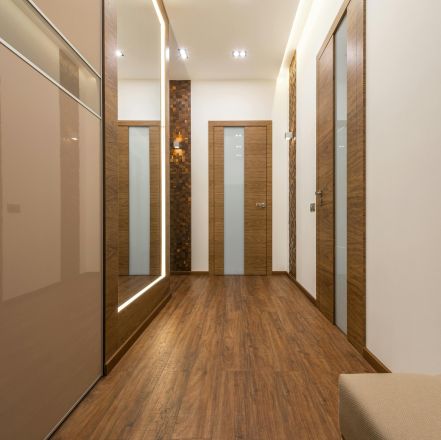 Sleek and luxurious hallway featuring wooden elements, elegant lighting, and modern design.